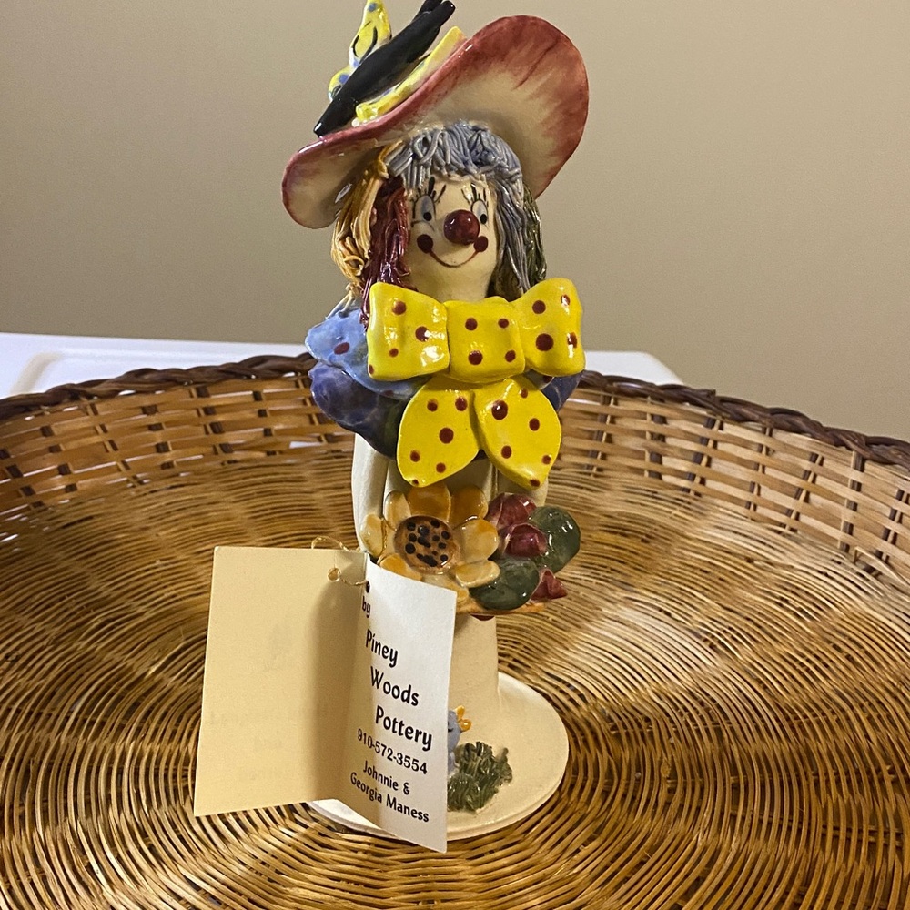 Piney words, pottery clown with basket of flowers, large bowtie